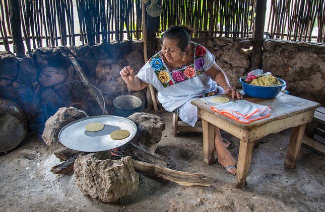 A Maya woman prepares tortillas made from maize grown locally in the state of Quintana Roo.