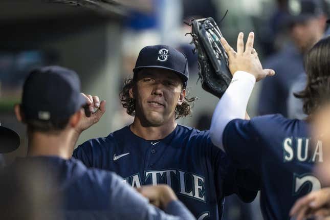 Aug 8, 2023; Seattle, Washington, USA; Seattle Mariners starting pitcher Logan Gilbert (36) is congratulated by teammates in the dugout during the seventh inning against the San Diego Padres at T-Mobile Park.