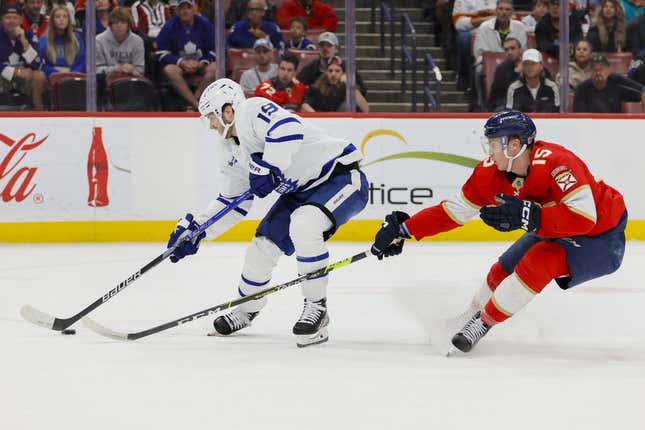 Mar 23, 2023; Sunrise, Florida, USA; Toronto Maple Leafs center Calle Jarnkrok (19) moves the puck ahead of Florida Panthers center Anton Lundell (15) during the first period at FLA Live Arena.