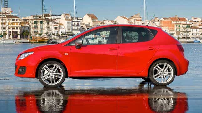 A red Seat Ibiza hatchback parked at the waterfront