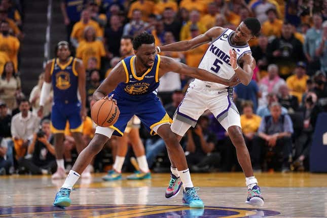 Apr 28, 2023; San Francisco, California, USA; Golden State Warriors forward Andrew Wiggins (22) dribbles the ball next to Sacramento Kings guard De&#39;Aaron Fox (5) in the third quarter during game six of the 2023 NBA playoffs at the Chase Center.