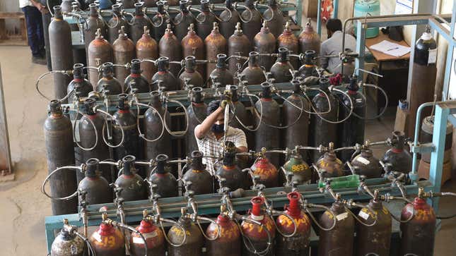 Technicians monitor medical oxygen refilling lines at a supply plant in Ahmedabad, India on May 3, 2021.