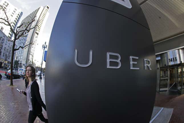 FILE - In this file photo taken, Dec. 16, 2014, a woman leaves the headquarters of Uber in San Francisco, Calif. Uber drivers are employees, not independent contractors, the Oregon Bureau of Labor and Industries said Wednesday, Oct. 14, 2015, in an opinion that takes direct aim at the business model for the popular ride-hailing company.