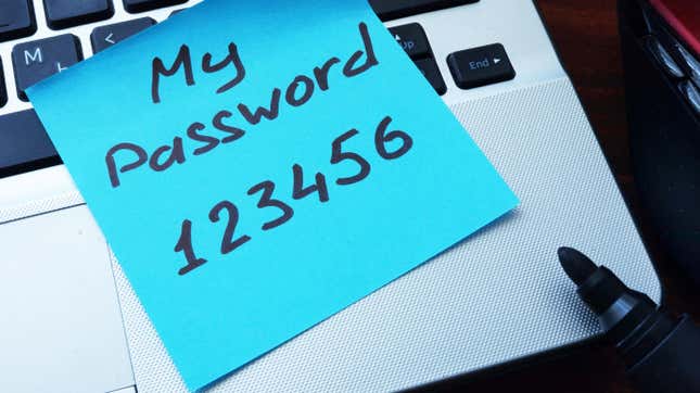A sticky note on a laptop keyboard reading "my password 123456"