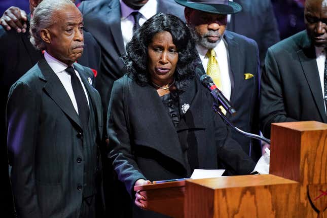 Flanked by Rev. Al Sharpton, left, and her husband Rodney Wells, RowVaughn Wells speaks during the funeral service for her son Tyre Nichols at Mississippi Boulevard Christian Church in Memphis, Tenn., on Wednesday, Feb. 1, 2023.