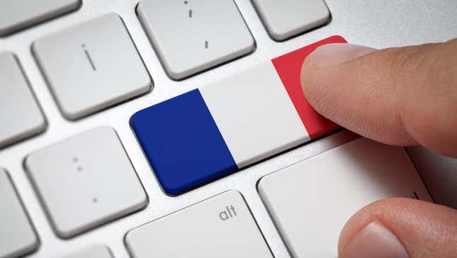 A keyboard with the French flag printed on one of the keys.