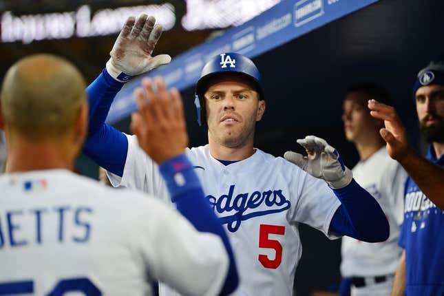 Aug 28, 2023; Los Angeles, California, USA; Los Angeles Dodgers first baseman Freddie Freeman (5) is greeted after hitting a solo home run against the Arizona Diamondbacks during the first inning at Dodger Stadium.