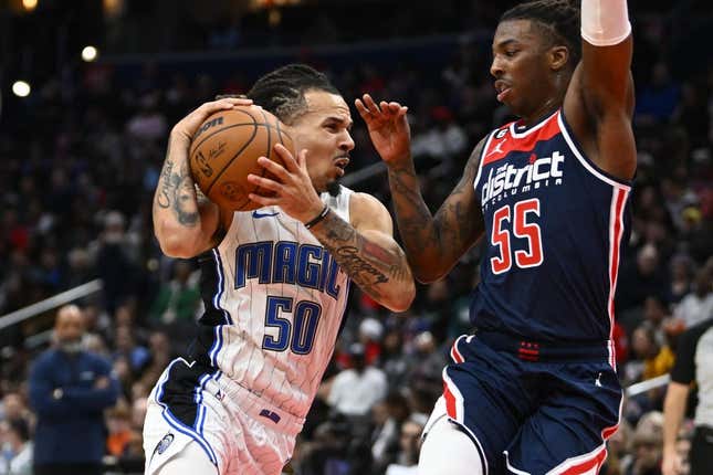 Jan 21, 2023; Washington, District of Columbia, USA; Orlando Magic guard Cole Anthony (50) drives against Washington Wizards guard Delon Wright (55) during the first half at Capital One Arena.