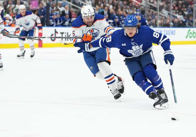 Mar 11, 2023; Toronto, Ontario, CAN; Toronto Maple Leafs right wing William Nylander (88) controls the puck as Edmonton Oilers defenseman Cody Ceci (5) tries to defend during the first period at Scotiabank Arena.
