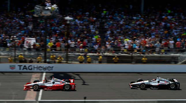 Team Penske drivers pass by the start/finish line at the Indy 500