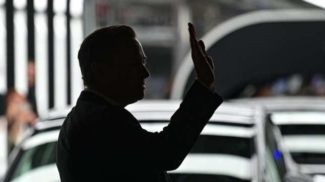 A photo of Elon Musk waving at Tesla's German Gigafactory.