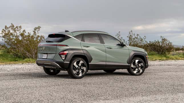 A Mirage Green 2024 Hyundai Kona parked in an open, paved lot