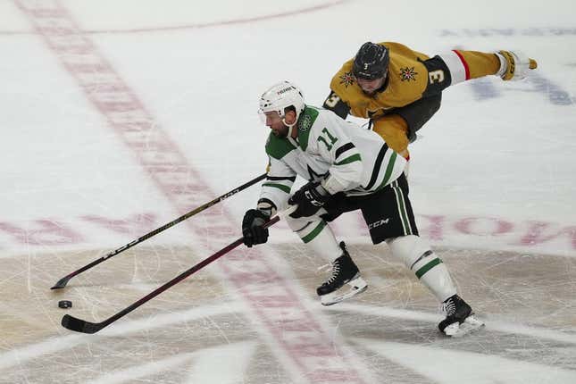 May 27, 2023; Las Vegas, Nevada, USA; Dallas Stars center Luke Glendening (11) skates with the puck past Vegas Golden Knights defenseman Brayden McNabb (3) during the third period in game five of the Western Conference Finals of the 2023 Stanley Cup Playoffs at T-Mobile Arena.
