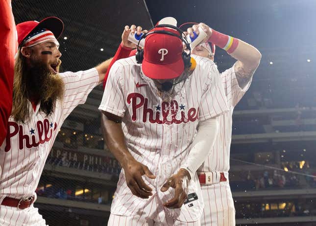 Jul 15, 2023; Philadelphia, Pennsylvania, USA; Philadelphia Phillies outfielder Johan Rojas (18) has water dumped on him by center fielder Brandon Marsh (16) and second baseman Bryson Stott (5) after a victory against the San Diego Padres at Citizens Bank Park.