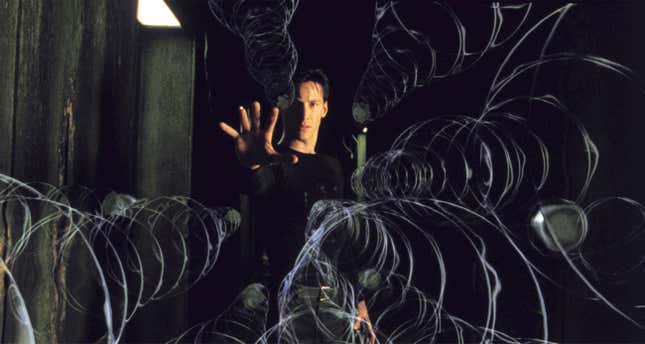 Keanu Reeves as Neo in The Matrix holding out his hand with magical spirals or something appearing to emanate from him.