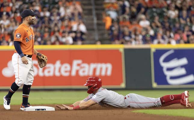Jun 16, 2023; Houston, Texas, USA; Cincinnati Reds shortstop Matt McLain (9) steal second base against Houston Astros second baseman Jose Altuve (27) in the fourth inning at Minute Maid Park.