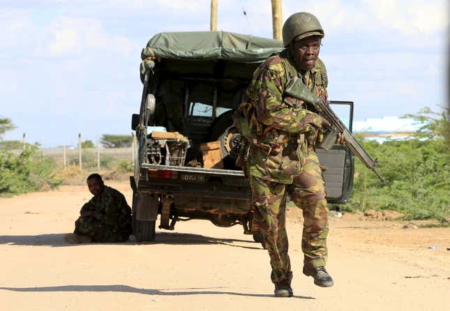 A Kenya Defense Force soldier runs for cover