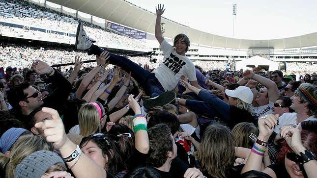 Teenage boy crowd-surfs at concert