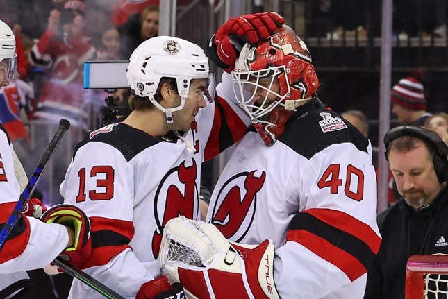 Feb 25, 2023; Newark, New Jersey, USA; New Jersey Devils center Nico Hischier (13) and New Jersey Devils goaltender Akira Schmid (40) celebrate their win over the Philadelphia Flyers at Prudential Center.