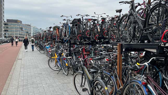 A photo of crowded racks of bicycles outside Amsterdam station. 