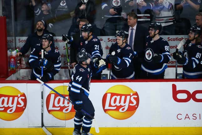 Apr 10, 2023; Winnipeg, Manitoba, CAN;  Winnipeg Jets defenseman Josh Morrissey (44) is congratulated by his team mates on his goal against the San Jose Sharks during the third period at Canada Life Centre.