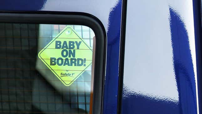 A photo of a car rear window with a sticker saying 'baby on board' 