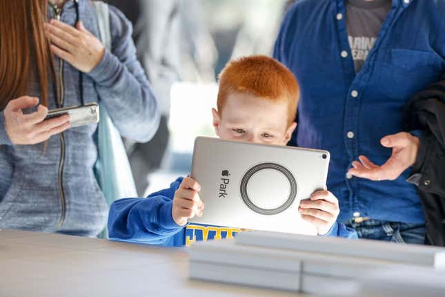A child plays with an Apple iPad at Apple's headquarters. 