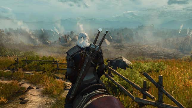 Geralt looks at a village off in the distance. 