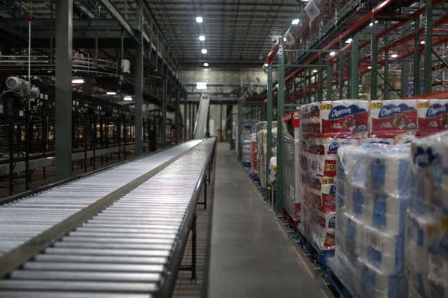 Pickers will stand alongside conveyor belts to pack bins full of bulk items.