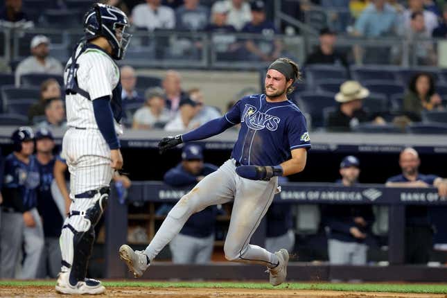 May 11, 2023; Bronx, New York, USA; Tampa Bay Rays right fielder Josh Lowe (15) scores a run against New York Yankees catcher Jose Trevino (39) on a double by first baseman Yandy Diaz (not pictured) during the fifth inning at Yankee Stadium.