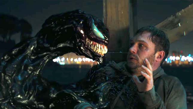The goopy Venom symbiote looks at the ill and cowering Eddie Brock.
