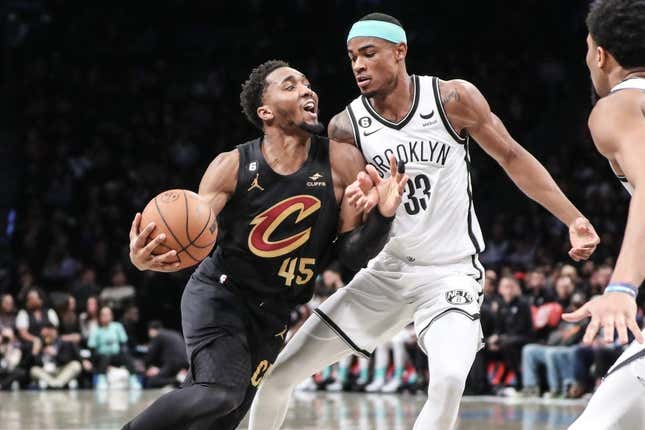 Mar 23, 2023; Brooklyn, New York, USA;  Cleveland Cavaliers guard Donovan Mitchell (45) looks to drive past Brooklyn Nets center Nic Claxton (33) in the second quarter at Barclays Center.