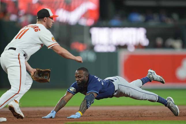 Sep 14, 2023; Baltimore, Maryland, USA; Tampa Bay Rays outfielder Randy Arozarena (56) slides in safely with a triple driving in two runs in the third inning against the Baltimore Orioles at Oriole Park at Camden Yards.