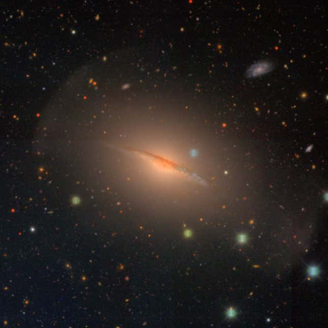 The Little Sombrero Galaxy, an orange disc.