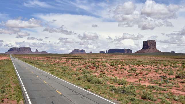 A photo of a highway passing through Monument Valley in Utah. 