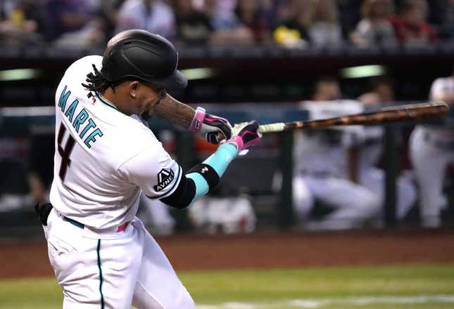 Jun 1, 2023; Phoenix, Arizona, USA; Arizona Diamondbacks second baseman Ketel Marte (4) hits an RBI double against the Colorado Rockies during the seventh inning at Chase Field.