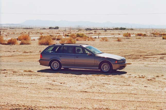 A gray 2002 BMW 5-series station wagon is parked at the Salton Sea.