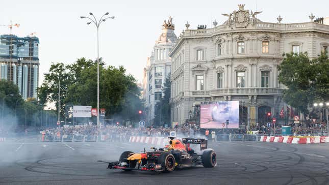 F1 driver Checo Perez drives the 'Red Bull RB7 (2011)' single-seater around the urban route between Puerta de Alcala, the Metropolis building, Cibeles and a stretch of Paseo Recoletos, on 15 July, 2023 in Madrid, Spain. Red Bull has transformed the center of Madrid into a Formula 1 circuit for the 'Formula 1 Red Bull Show Run Comunidad de Madrid' exhibition, where several sports cars participate in this sporting event.