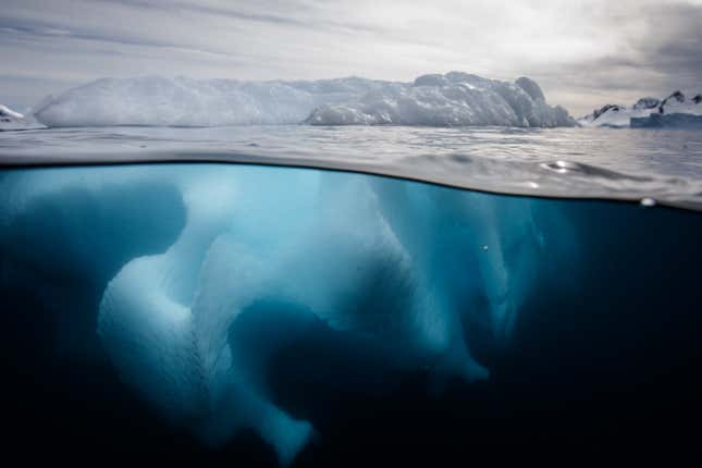 An underwater photo of an iceberg in the Southern Ocean offshore the Antarctic Peninsula.
