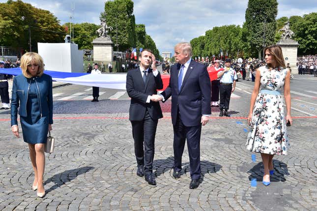 Donald Trump and Emmanuel Macron, flanked by Brigitte Macron (left) and Melania Trump during a long-lasting Bastille Day handshake on July 14, 2017.
