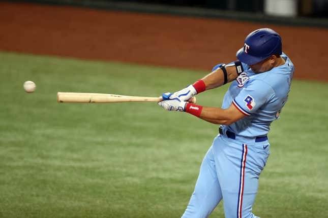 Jun 4, 2023; Arlington, Texas, USA; Texas Rangers first baseman Nathaniel Lowe (30) singles in the third inning against the Seattle Mariners at Globe Life Field.