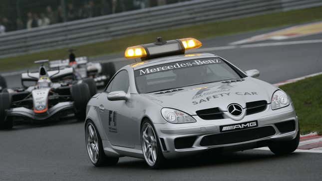 A Mercedes-Benz safety car leads a pack of F1 cars. 