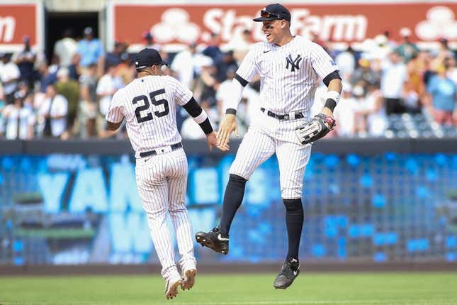 Aug 5, 2023; Bronx, New York, USA;  New York Yankees second baseman Gleyber Torres (25) and right fielder Aaron Judge (99) celebrate after defeating the Houston Astros 3-1 at Yankee Stadium.