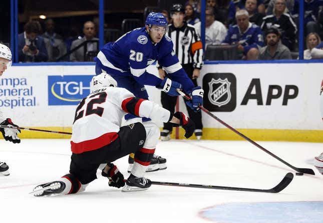 Nov 1, 2022; Tampa, Florida, USA; Tampa Bay Lightning left wing Nicholas Paul (20) skates with the puck as Ottawa Senators defenseman Nikita Zaitsev (22) defends  during the third period at Amalie Arena.