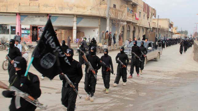 Fighters of al-Qaeda linked to the Islamic State of Iraq and the Levant carry their weapons during a parade at the Syrian town of Tel Abyad, near the border with Turkey in Jan. 2014.
