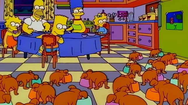A screenshot of The Simpsons shows a bunch of puppies eating food near the family. 