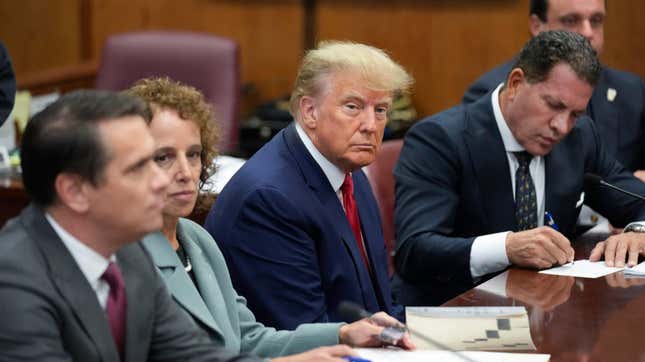Former President Donald Trump sits at the defense table with his defense team in a Manhattan court, Tuesday, April 4, 2023, in New York. Trump is set to appear in a New York City courtroom on charges related to falsifying business records in a hush money investigation, the first president ever to be charged with a crime.