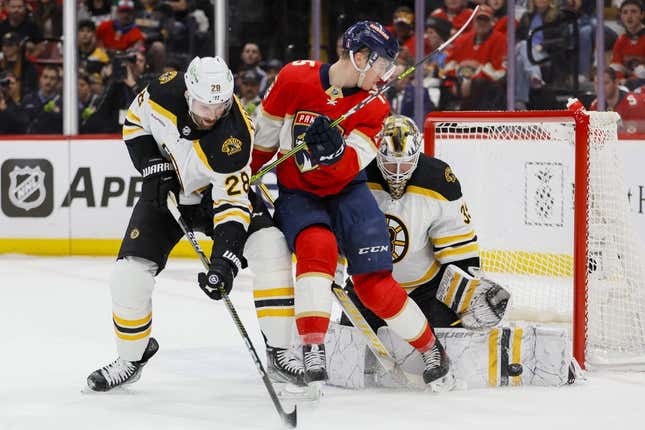 Apr 21, 2023; Sunrise, Florida, USA; Florida Panthers center Anton Lundell (15) deflects the puck and Boston Bruins goaltender Linus Ullmark (35) makes a save as defenseman Derek Forbort (28) defends during the first period in game three of the first round of the 2023 Stanley Cup Playoffs at FLA Live Arena.