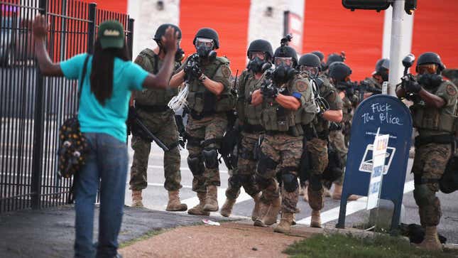 Police force protestors from the business district into nearby neighborhoods on August 11, 2014 in Ferguson, Missouri following the killing of Michael Brown at the hands of police.