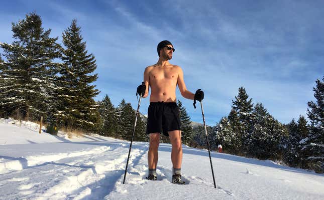 Author Scott Carney hiking shirtless in the snow.
